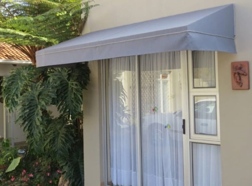 Wedge awning installed over sliding door