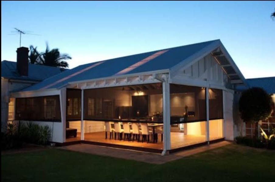 Out Door roller blinds installed - entertainment area - night time view