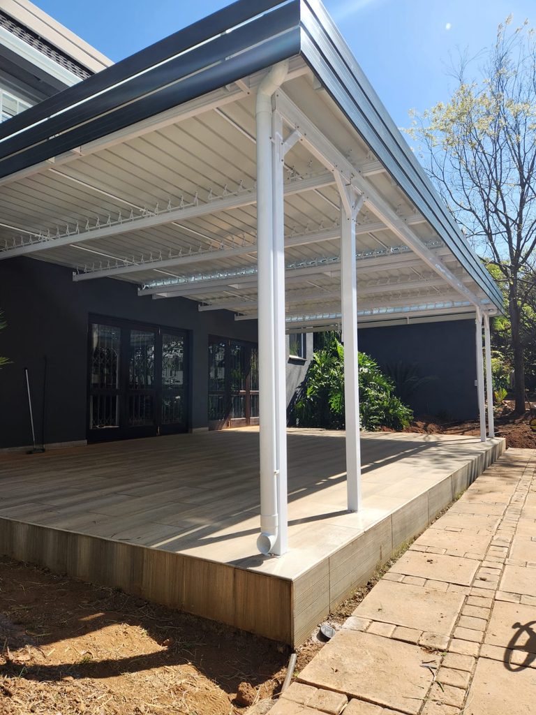 Adjustable louvered awning installed over entertainment area